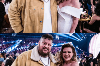 At a recent Jelly Roll concert, the music paused, the lights dimmed, and tens of thousands of fans held their breath as 8-year-old Remington Clarkson, Kelly Clarkson’s son, stepped into the spotlight. With a trembling voice, he began to sing his mother’s heartbreak anthem, “Because of You.” Supported by Jelly Roll’s quiet encouragement, Remy found his rhythm, transforming the song into a deeply personal moment. The crowd stood in stunned silence as Kelly watched her son step into her world—his voice not just covering the song but rewriting it with his own heart. The emotional silence before the standing ovation became the most powerful moment of the night, proving that sometimes, the loudest moments come in the quiet.